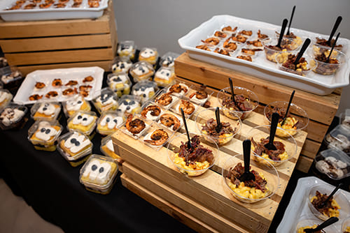 Sweet dishes counter featuring a variety of desserts by Wolfman Catering